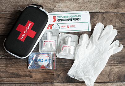 A naloxone kit with the inner contents being shown. 