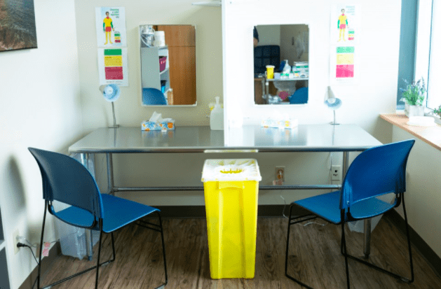 The Guelph safe injection site. This has a glass, a chair, and a syringe disposal bin. 
